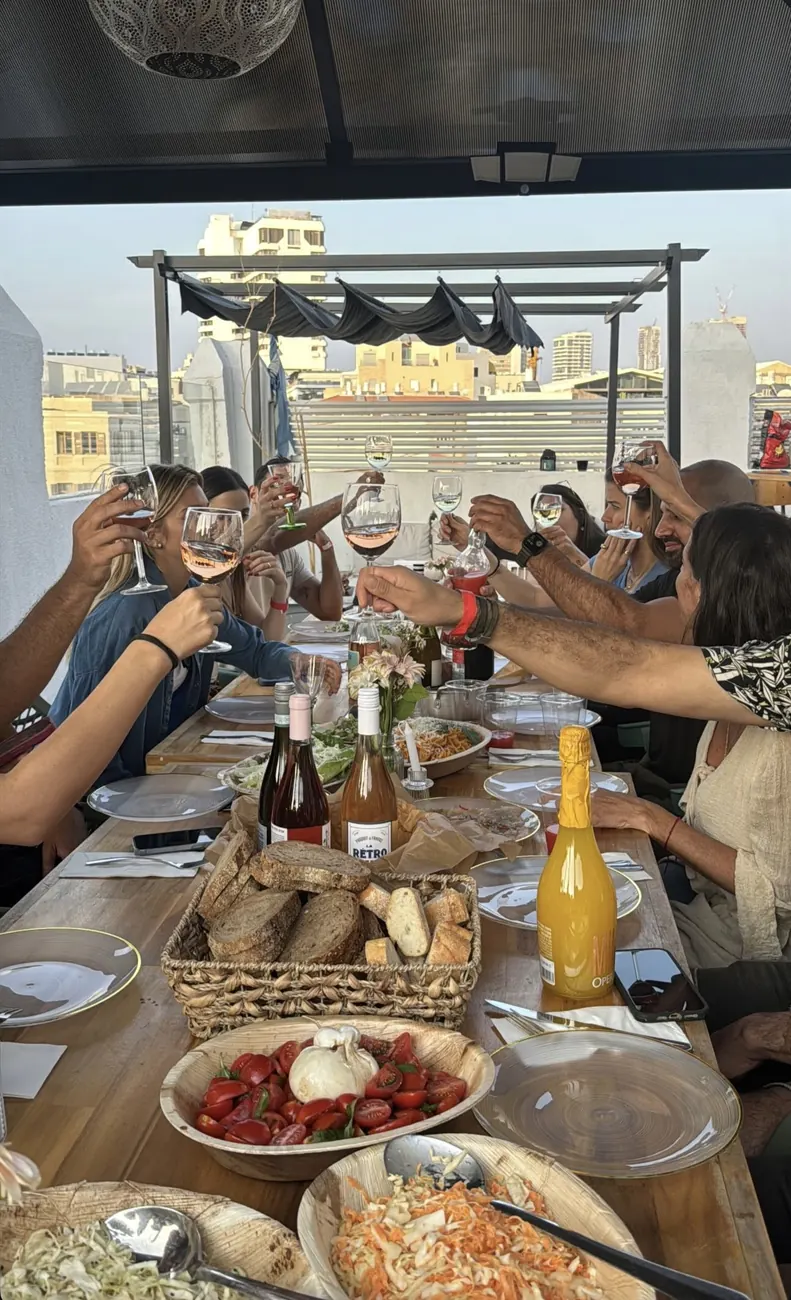 A toast at a Habibi rooftop Friday dinner